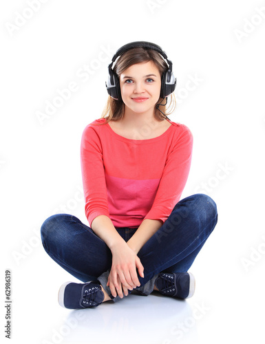 Photo: Woman with headphones listening music on player Woman with headphones listening music on player