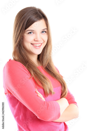 Photo: Beautiful young woman standing with arms crossed Beautiful young woman standing with arms crossed