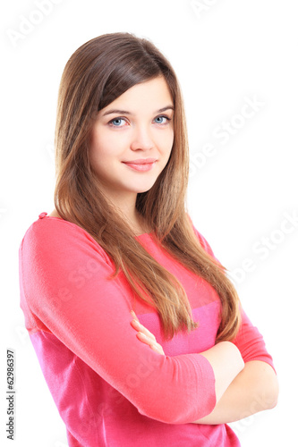 Photo: Beautiful young woman standing with arms crossed Beautiful young woman standing with arms crossed