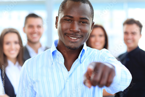 Photo: Handsome business man pointing his finger at you Handsome business man pointing his finger at you