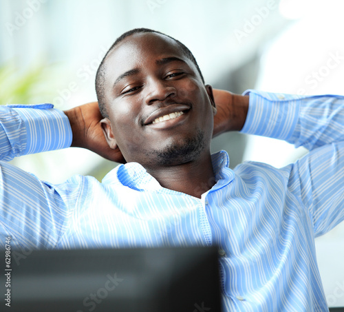 Photo: relaxed businessman looking away. african american businessman relaxed businessman looking away. african american businessman