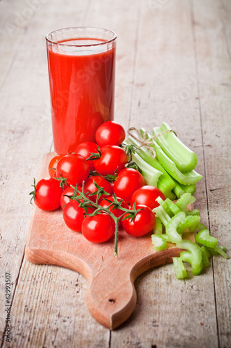 Photo: tomato juice in glass, fresh tomatoes and green celery tomato juice in glass, fresh tomatoes and green celery