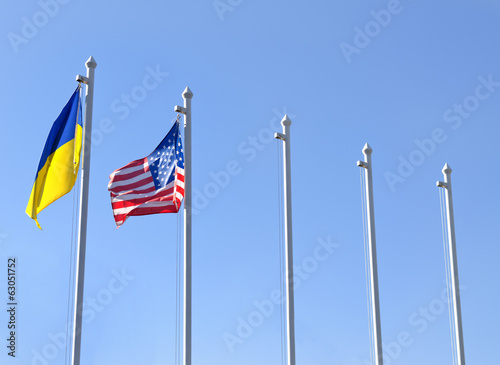 Photo: Fag of Ukraine fluttering next to the flag of USA Fag of Ukraine fluttering next to the flag of USA