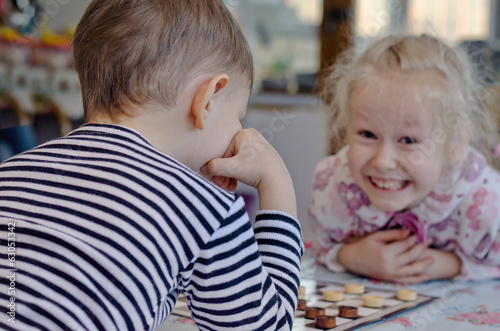 Photo: Cute little girl grinning at her brother Cute little girl grinning at her brother