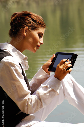 Photo: a woman with laptop in park ui a woman with laptop in park ui