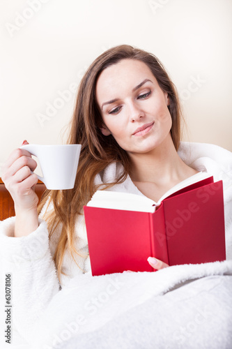 Photo: Woman after shower with book Woman after shower with book
