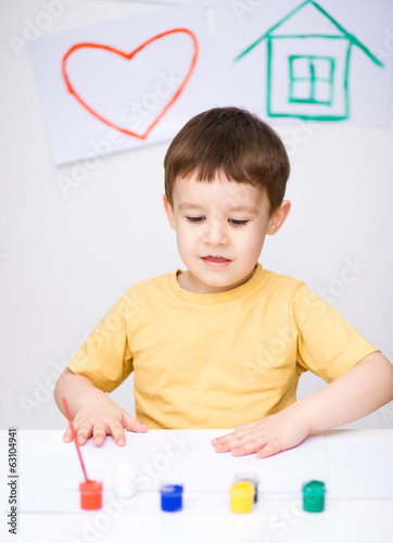 Photo: Portrait of a cute boy playing with paints Portrait of a cute boy playing with paints