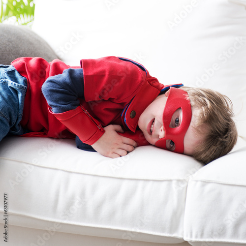 Photo: Little superhero resting on sofa Little superhero resting on sofa