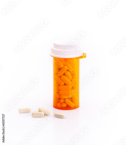 Photo: Pills and supplementary food bottle isolated Pills and supplementary food bottle isolated