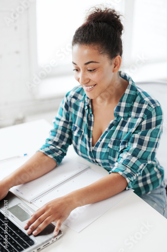 Photo: international student girl with laptop at school international student girl with laptop at school