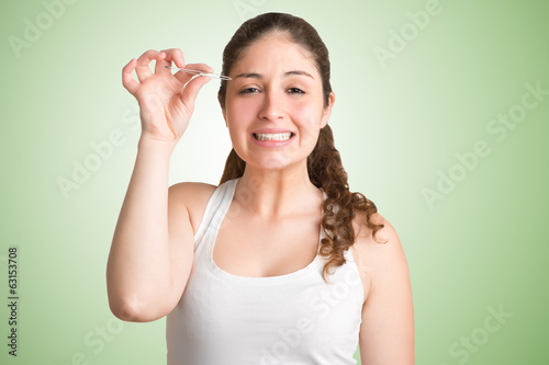 Photo: Woman Plucking Eyebrows Woman Plucking Eyebrows