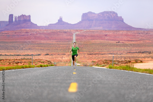 Photo: Running man - runner on road by Monument Valley Running man - runner on road by Monument Valley