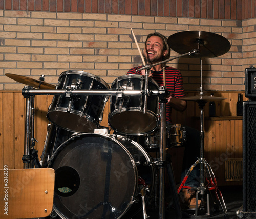 Photo: Energetic rock drummer in action. Long blonde hair. Jam session. Energetic rock drummer in action. Long blonde hair. Jam session.