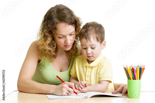 Photo: kid boy and mother draw with colorful pencils kid boy and mother draw with colorful pencils