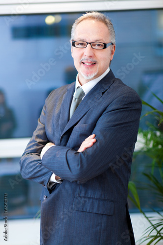 Photo: Senior businessman in his office Senior businessman in his office