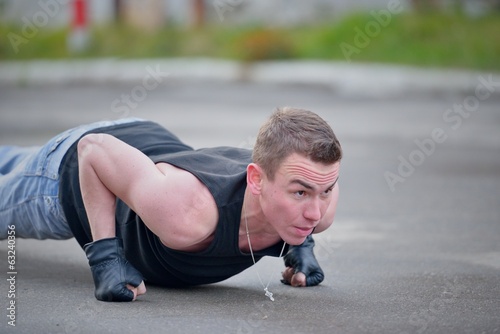 Photo: Man doing pushups on the street Man doing pushups on the street