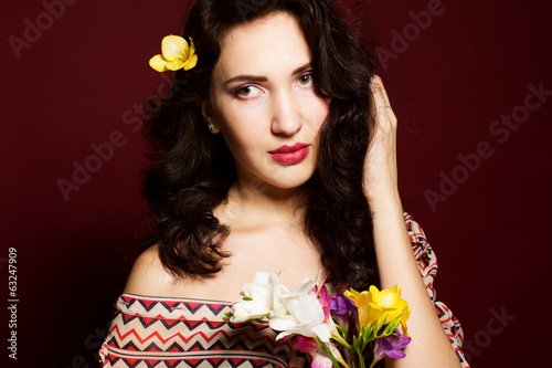 Photo: Pretty brunette lady with fresia flowers Pretty brunette lady with fresia flowers