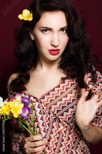 Photo: Pretty brunette lady with fresia flowers Pretty brunette lady with fresia flowers