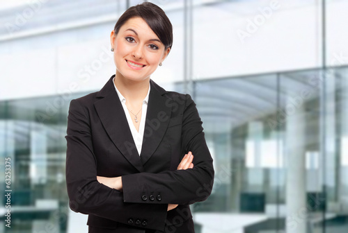 Photo: Smiling businesswoman in her office Smiling businesswoman in her office