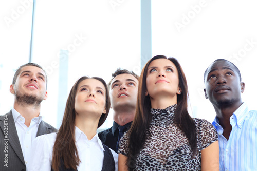 Photo: Group of executives looking up at something Group of executives looking up at something