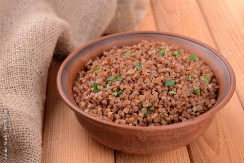 Photo: Boiled buckwheat in bowl on table close-up Boiled buckwheat in bowl on table close-up