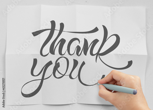 Photo: businessman hand show design word THANK YOU on crumpled paper as businessman hand show design word THANK YOU on crumpled paper as