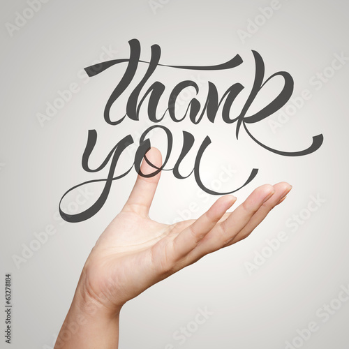 Photo: hand showing hand drawn design word THANK YOU as concept hand showing hand drawn design word THANK YOU as concept