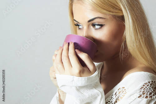 Photo: Beautiful woman drinking Coffee.Cup of tea.girl in the Morning Beautiful woman drinking Coffee.Cup of tea.girl in the Morning