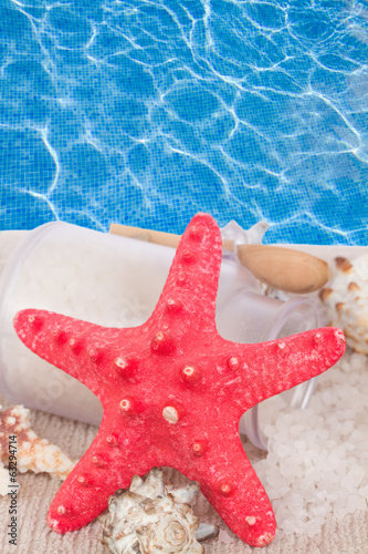 Photo: Red starfish with sea spa treatment setting Red starfish with sea spa treatment setting