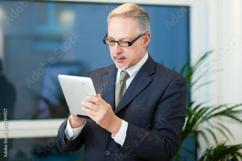 Photo: Businessman using a tablet Businessman using a tablet