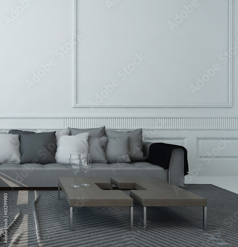 Photo: Living room interior with gray couch against white wall Living room interior with gray couch against white wall