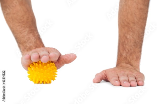 Photo: Close-up of hand over stress ball Close-up of hand over stress ball
