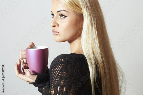 Photo: Beautiful blond woman with Coffee. Cup of tea. Hot drink Beautiful blond woman with Coffee. Cup of tea. Hot drink