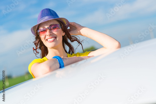 Photo: Young woman got out of car window Young woman got out of car window