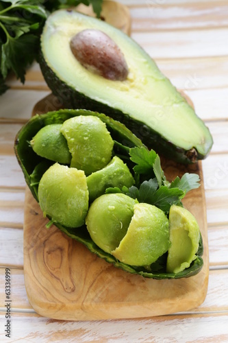 Photo: salad of fresh avocado on a wooden board salad of fresh avocado on a wooden board