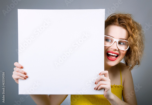 Photo: Smile woman with blank white board or panel Smile woman with blank white board or panel