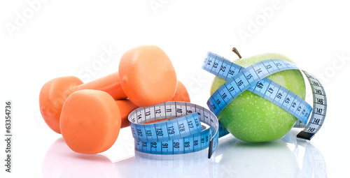 Photo: Dumbbell with apple and measure tape Dumbbell with apple and measure tape