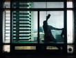 silhouette of a man cleaning building glass silhouette of a man cleaning building glass