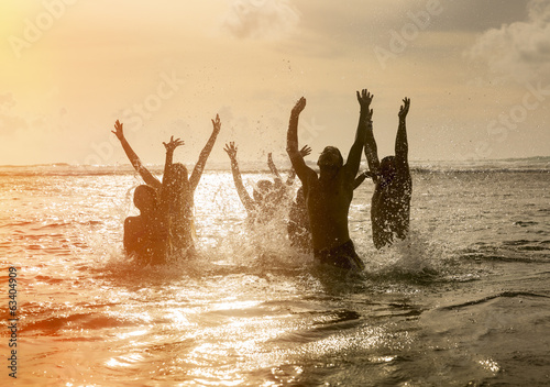 Photo: Silhouettes of people jumping in ocean Silhouettes of people jumping in ocean