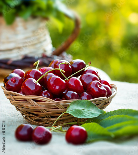 Photo: Fresh organic cherries in wicker basket Fresh organic cherries in wicker basket