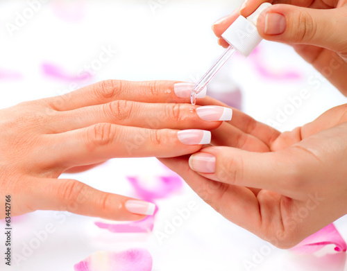 Photo: Cuticle oil. Manicure and Hands Spa. Woman Hands Closeup Cuticle oil. Manicure and Hands Spa. Woman Hands Closeup