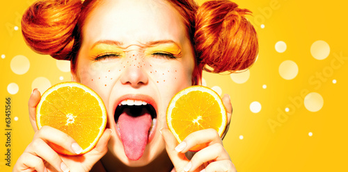 Photo: Beauty joyful teen girl with juicy oranges. Freckles Beauty joyful teen girl with juicy oranges. Freckles