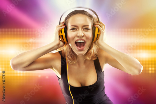 Photo: Happy woman listening music with headphones Happy woman listening music with headphones