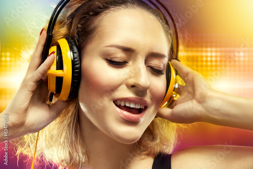 Photo: Happy woman listening music with headphones Happy woman listening music with headphones