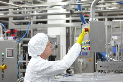 Photo: technician at control panel in lab - pressing buttons technician at control panel in lab - pressing buttons