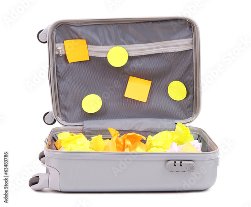 Photo: Open suitcase with paper stickers isolated on white Open suitcase with paper stickers isolated on white