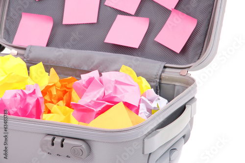 Photo: Open suitcase with paper stickers isolated on white Open suitcase with paper stickers isolated on white