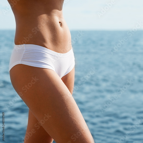 Photo: Young woman on a sea background Young woman on a sea background