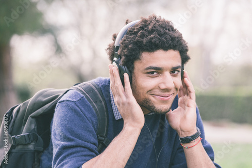 Photo: Mixed-Race Student Listening Music Mixed-Race Student Listening Music