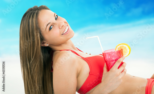 Photo: Woman sunbathing on a beach Woman sunbathing on a beach